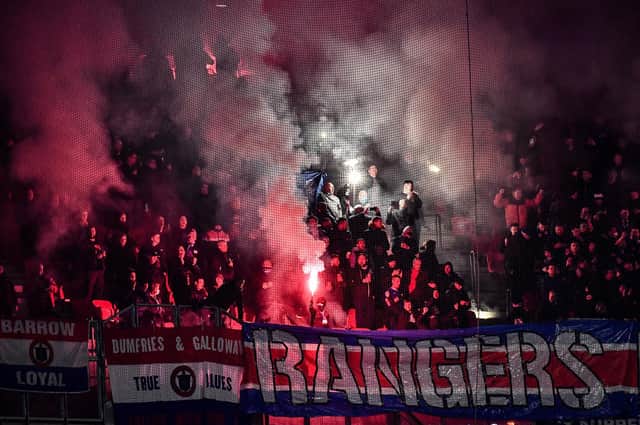 Rangers fans light flares at the Europa League match in Lyon on December 9. (Photo by JEFF PACHOUD / AFP) (Photo by JEFF PACHOUD/AFP via Getty Images)