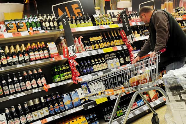 A customer looks at alcohol on the shelf at a supermarket. Picture: PA