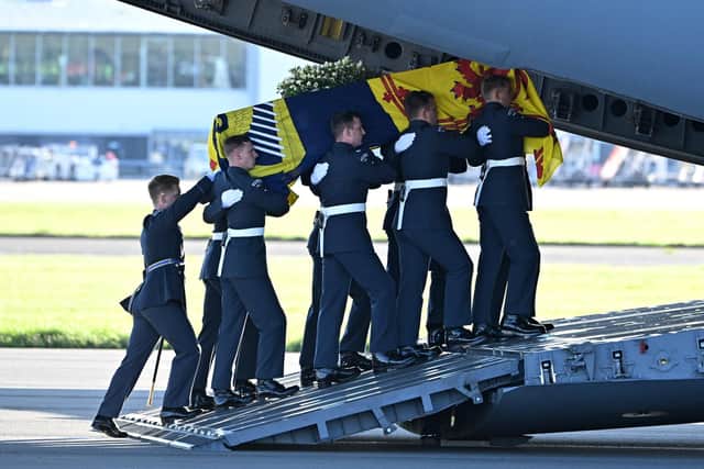 Pallbearers from the Queen's Colour Squadron of the Royal Air Force (RAF) carry the coffin of Elizabeth II, draped in the Royal Standard of Scotland, into a RAF C17 aircraft at Edinburgh Airport. Picture: Paul Ellis - WPA Pool/Getty Images