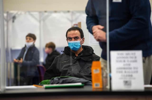 A poll watcher looks on as clerks check voters in at a polling station in New Hampshire. Picture: Joseph Prezioso/AFP/Getty