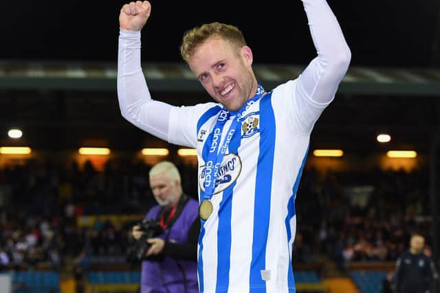 Rory McKenzie celebrates with his first medal in 11 years at Kilmarnock's first-team. (Photo by Ross MacDonald / SNS Group)