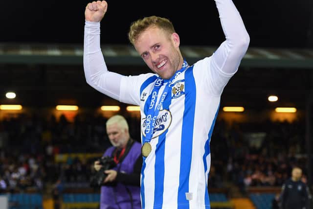 Rory McKenzie celebrates with his first medal in 11 years at Kilmarnock's first-team. (Photo by Ross MacDonald / SNS Group)
