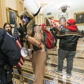 Supporters of President Donald Trump are confronted by US Capitol Police officers outside the Senate Chamber in the US Capitol (Picture: Manuel Balce Ceneta/AP)