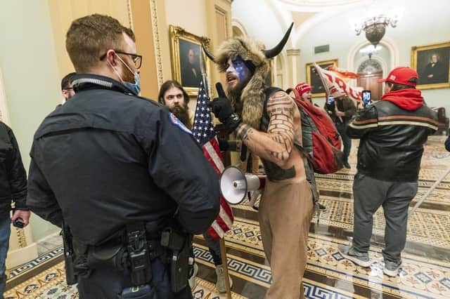 Supporters of President Donald Trump are confronted by US Capitol Police officers outside the Senate Chamber in the US Capitol (Picture: Manuel Balce Ceneta/AP)