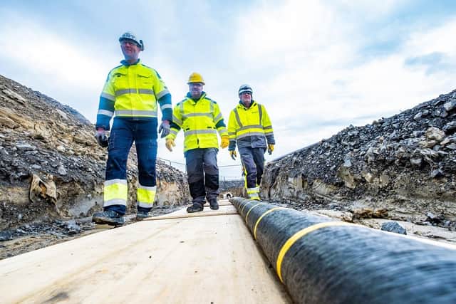 Undated handout photo issued by SSEN (Scottish and Southern Electricity Networks) of engineers inspecting part of the subsea cable before it is laid. The cable is part of a £660M project to connect Shetland to the energy grid. Issue date: Friday July 8, 2022.