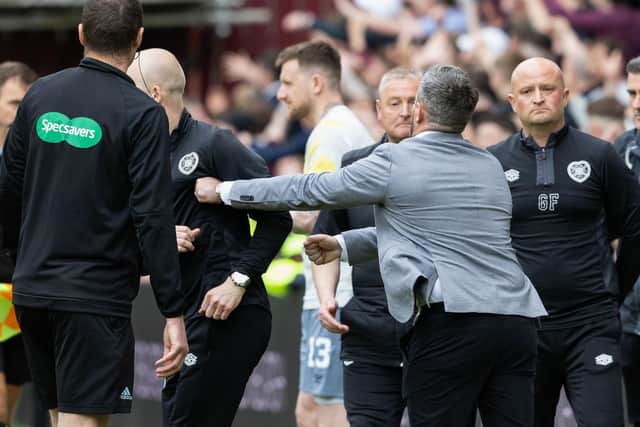 Hearts' interim manger Steven Naismith (L) and Hibs manager Lee Johnson (C) clash at the end of the match.