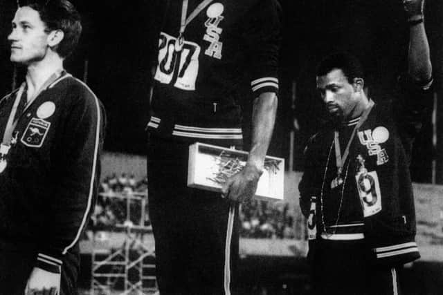 Tommie Smith and John Carlos raise their fists in a civil rights gesture on the Olympic medal stand in Mexico City in 1968 (Picture: AFP via Getty Images)