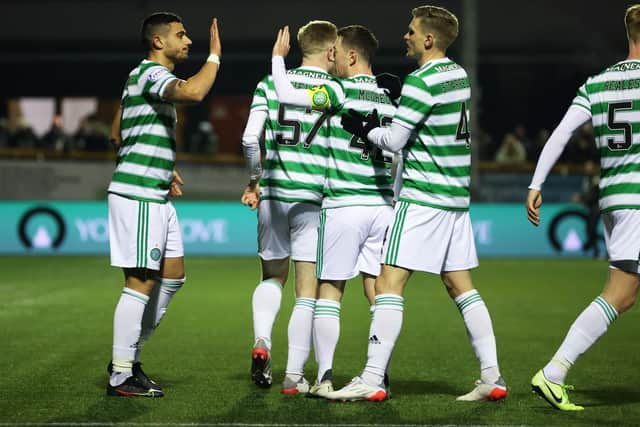 Celtic's Giorgous Giakoumakis celebrates with Carl Starfelt and Callum McGregor.