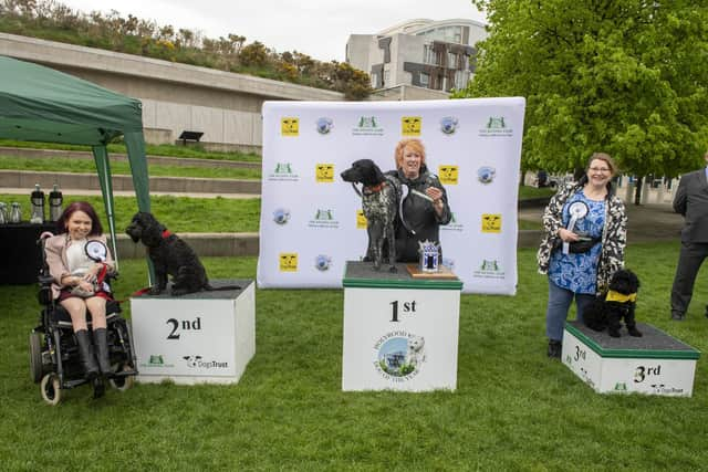 Christine Grahame MSP and Mabel are announced as winners of this year's Holyrood Dog of the Year competition organised jointly by Dogs Trust and The Kennel Club. 
Coming in second was Pam Duncan-Glancy, MSP for the Glasgow region, with her cockapoo Tony. And taking third place on the podium was Dogs Trust dog Ollie, who was being looked after by Clare Adamson.