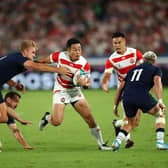 Japan wing Kenki Fukuoka breaks between Scotland centre Chris Harris, left, and winger Darcy Graham during the 2019 Rugby World Cup match in Yokohama. (Photo by Stu Forster/Getty Images)