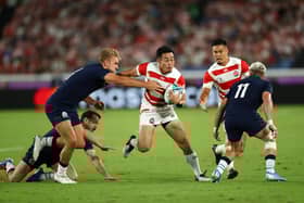 Japan wing Kenki Fukuoka breaks between Scotland centre Chris Harris, left, and winger Darcy Graham during the 2019 Rugby World Cup match in Yokohama. (Photo by Stu Forster/Getty Images)