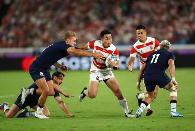 Japan wing Kenki Fukuoka breaks between Scotland centre Chris Harris, left, and winger Darcy Graham during the 2019 Rugby World Cup match in Yokohama. (Photo by Stu Forster/Getty Images)