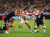 Japan wing Kenki Fukuoka breaks between Scotland centre Chris Harris, left, and winger Darcy Graham during the 2019 Rugby World Cup match in Yokohama. (Photo by Stu Forster/Getty Images)