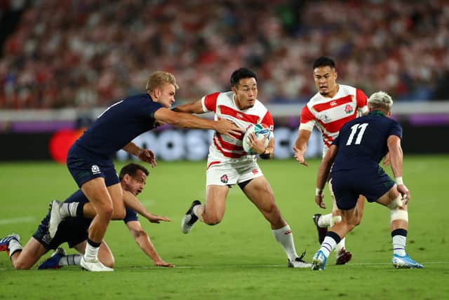 Japan wing Kenki Fukuoka breaks between Scotland centre Chris Harris, left, and winger Darcy Graham during the 2019 Rugby World Cup match in Yokohama. (Photo by Stu Forster/Getty Images)