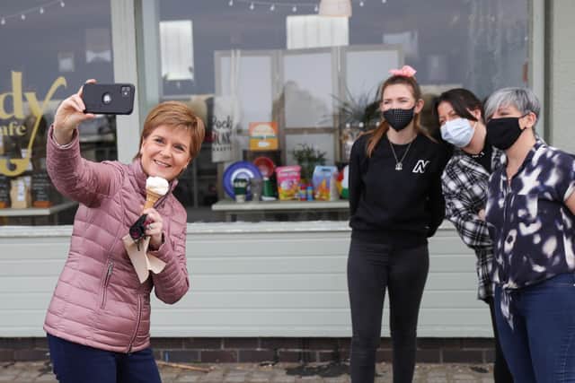 Nicola Sturgeon takes a selfie while having an ice cream in Ayr during campaigning for the Scottish Parliament election (Picture: Russell Cheyne/PA)