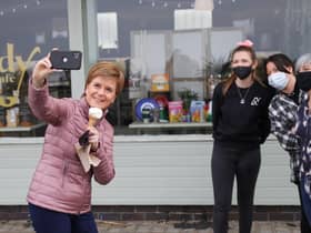 Nicola Sturgeon takes a selfie while having an ice cream in Ayr during campaigning for the Scottish Parliament election (Picture: Russell Cheyne/PA)