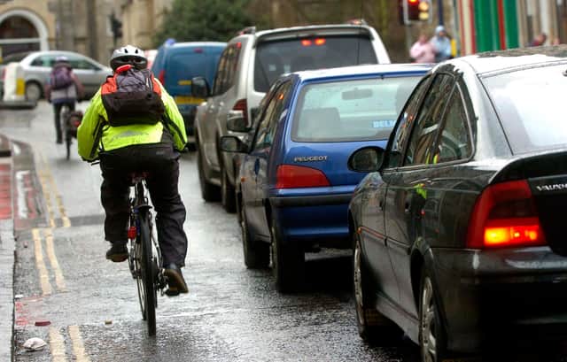Cyclists/bikes and traffic/cars, rush hour, pollution, exhusts, fumes