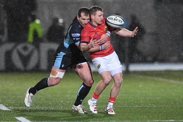 Glasgow Warriors' Fraser Brown challenges Munster's Ben Healy - now at Edinburgh - during a match in 2022.