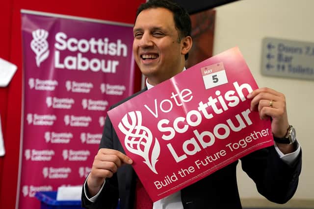 Scottish Labour leader Anas Sarwar holds a poster showing the new Scottish Labour logo during the Scottish Labour conference at Glasgow Royal Concert Hall.