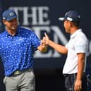 Bryson DeChambeau fist bumps Japan's Ryosuke Kinoshita after a practice round for the 149th Open at Royal St George's. Picture: Andy Buchanan/AFP via Getty Images.