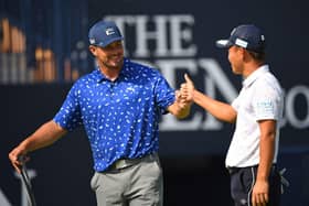 Bryson DeChambeau fist bumps Japan's Ryosuke Kinoshita after a practice round for the 149th Open at Royal St George's. Picture: Andy Buchanan/AFP via Getty Images.