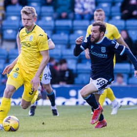 Hibs' Josh Doig and Dundee's Paul McMullan tussle during Tuesday night's match at Dens Park.