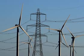 A wind farm amongst existing electricity pylons. PIC: Gareth Fuller/PA Wire