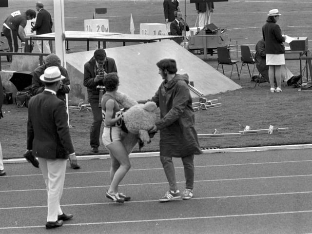 An unidentified female athlete with Dunky Dick, the Games mascot, on the last day of the 1970 Commonwealth Games in Edinburgh.