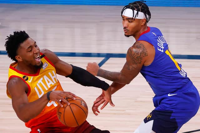 Donovan Mitchell, left, in action for Utah Jazz against Gary Harris of the Denver Nuggets. Picture: Kevin C Cox/Getty Images