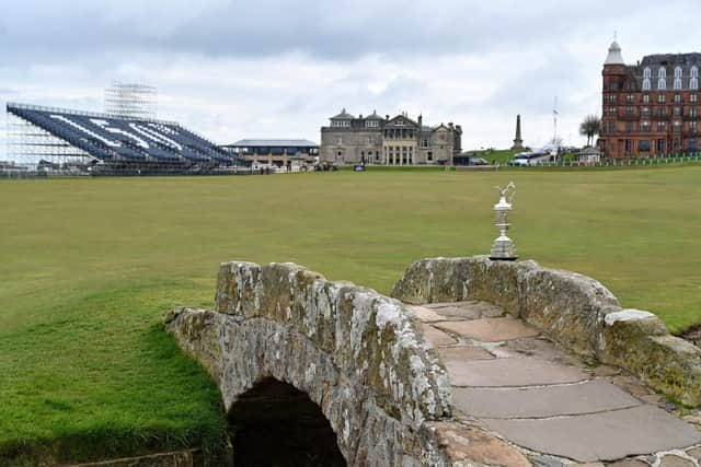 The Claret Jug, the trophy for the Champion Golfer of the Year, is pictured on the Swilcan Bridge, during a preview ahead of the 150th British Open Golf Championship at The Old Course at St Andrews. Picture: Glyn Kirk/AFP via Getty Images