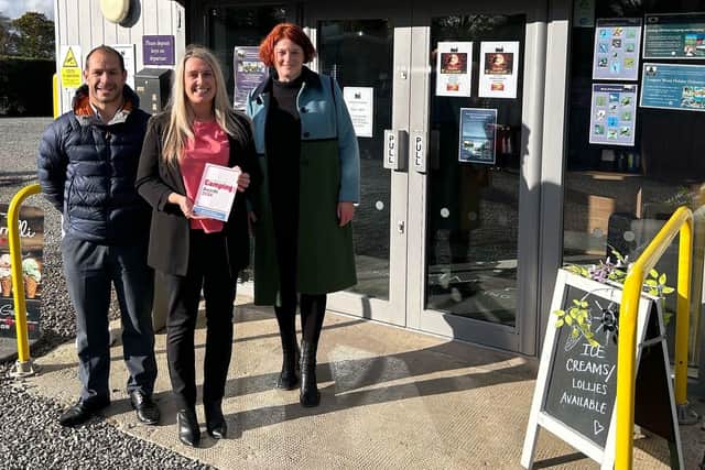 Angie Purves displays one of the park's recent awards with WCF's Daniel Sowerby and Jo Ritzema