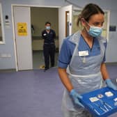 Deputy charge nurse Katie McIntosh arrives to administer the first of two Pfizer/BioNTech Covid-19 vaccine jabs to staff at the Western General Hospital, in Edinburgh, on Tuesday.