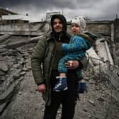 A man holds a child as he flees the city of Irpin, west of Kyiv, on March 7 (Picture: Aris Messinis/AFP via Getty Images)