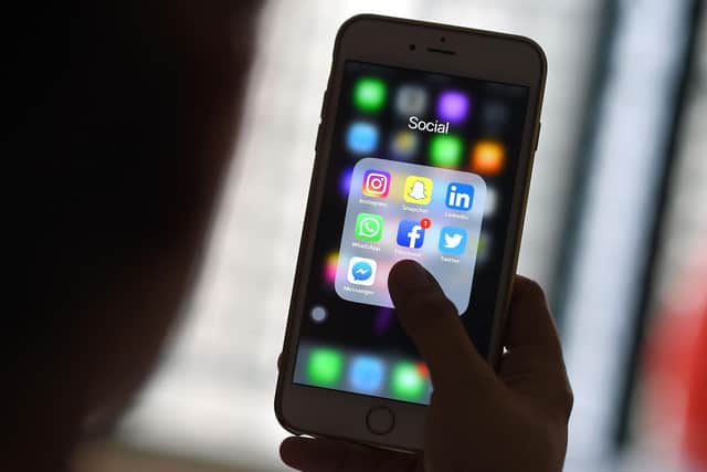 This photo illustration taken on March 22, 2018 shows a woman looking at Social Networking applications Facebook, Instagram, Snapchat, Whatsapp, Twitter, Messenger and Linkedin on a smartphone in Kuala Lumpur. (Photo by Manan VATSYAYANA / AFP) (Photo by MANAN VATSYAYANA/AFP via Getty Images)