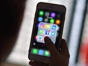This photo illustration taken on March 22, 2018 shows a woman looking at Social Networking applications Facebook, Instagram, Snapchat, Whatsapp, Twitter, Messenger and Linkedin on a smartphone in Kuala Lumpur. (Photo by Manan VATSYAYANA / AFP) (Photo by MANAN VATSYAYANA/AFP via Getty Images)