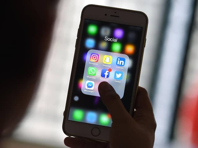 This photo illustration taken on March 22, 2018 shows a woman looking at Social Networking applications Facebook, Instagram, Snapchat, Whatsapp, Twitter, Messenger and Linkedin on a smartphone in Kuala Lumpur. (Photo by Manan VATSYAYANA / AFP) (Photo by MANAN VATSYAYANA/AFP via Getty Images)