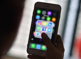 This photo illustration taken on March 22, 2018 shows a woman looking at Social Networking applications Facebook, Instagram, Snapchat, Whatsapp, Twitter, Messenger and Linkedin on a smartphone in Kuala Lumpur. (Photo by Manan VATSYAYANA / AFP) (Photo by MANAN VATSYAYANA/AFP via Getty Images)