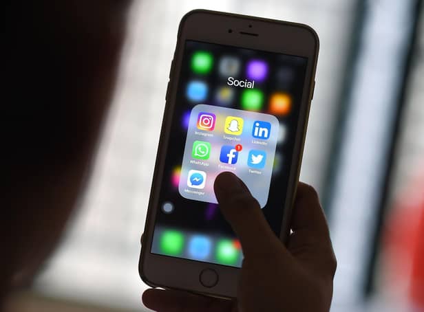 This photo illustration taken on March 22, 2018 shows a woman looking at Social Networking applications Facebook, Instagram, Snapchat, Whatsapp, Twitter, Messenger and Linkedin on a smartphone in Kuala Lumpur. (Photo by Manan VATSYAYANA / AFP) (Photo by MANAN VATSYAYANA/AFP via Getty Images)