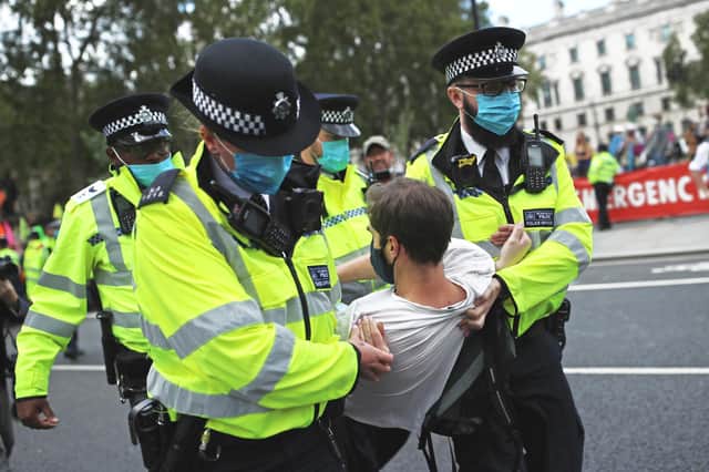 Police Officers make an arrest during an Extinction Rebellion protest in London (Picture: Dan Kitwood/Getty Images)