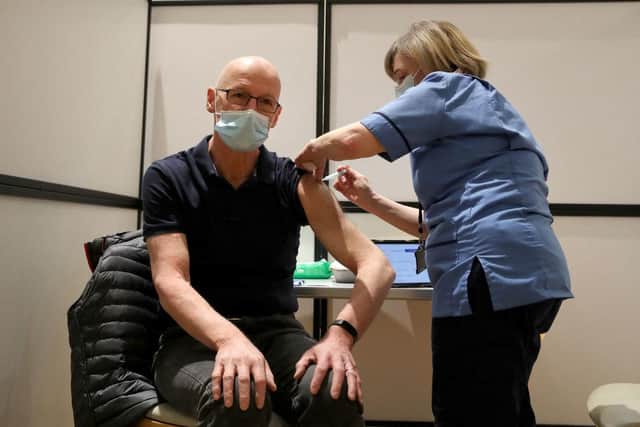 John Swinney, pictured getting a Covid jag in 2021, says Scots can be confident in NHS (Picture: Andrew Milligan / POOL / AFP)