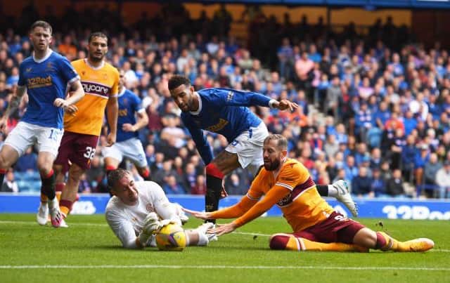 Rangers goalkeeper Allan McGregor clutches the ball under pressure from Motherwell striker Kevin van Veen. (Photo by Craig Foy / SNS Group)