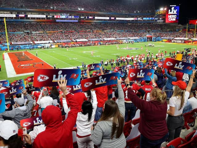 Fans hold up signs in the stands during Super Bowl LV between the Tampa Bay Buccaneers and the Kansas City Chiefs at Raymond James Stadium on 7 February 2021. (Pic: Getty Images)