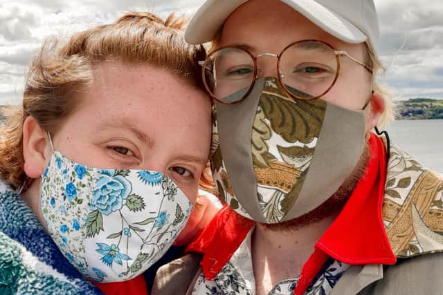 Catrin Evans, pictured with her partner Coren Childs, wearing masks she has made as part of the sewing business she started during lockdown.