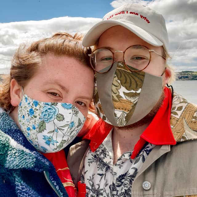 Catrin Evans, pictured with her partner Coren Childs, wearing masks she has made as part of the sewing business she started during lockdown.