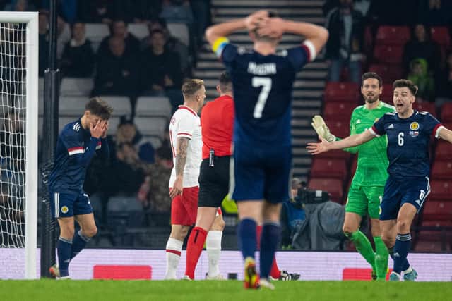 Scotland players react to the penalty decision that led to Poland's injury-time equaliser. (Photo by Ross MacDonald / SNS Group)