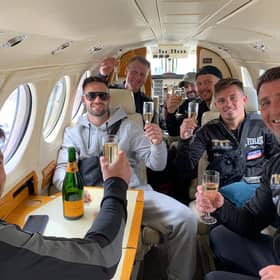 Josh Taylor and his team sip champagne in a private jet on the final leg of their journey home to Scotland. Picture: MTK Global Boxing