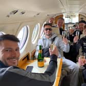 Josh Taylor and his team sip champagne in a private jet on the final leg of their journey home to Scotland. Picture: MTK Global Boxing