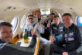 Josh Taylor and his team sip champagne in a private jet on the final leg of their journey home to Scotland. Picture: MTK Global Boxing