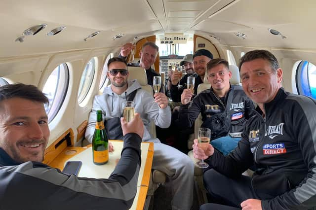 Josh Taylor and his team sip champagne in a private jet on the final leg of their journey home to Scotland. Picture: MTK Global Boxing