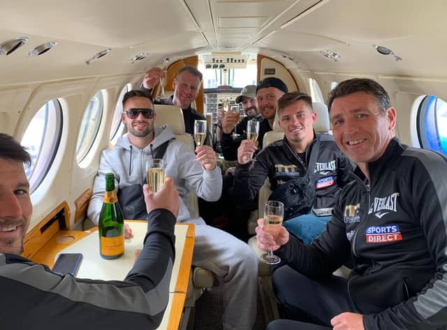 Josh Taylor and his team sip champagne in a private jet on the final leg of their journey home to Scotland. Picture: MTK Global Boxing